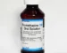 Promethazine DM syrup bottle with measuring cup for cough relief