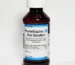 Promethazine DM syrup bottle with measuring cup for cough relief