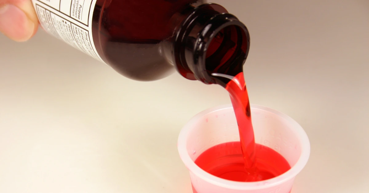 Prescription only opioid cough syrup bottle with dosage measuring cap
