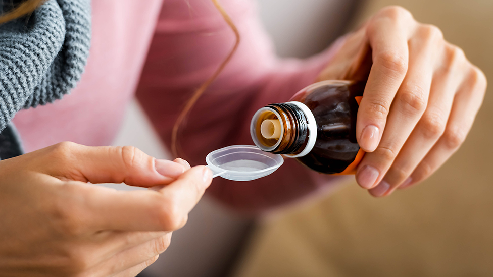 Product bottle labeled cough medicine with codeine for severe cold symptom treatment